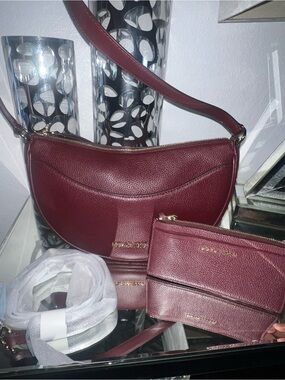 Michael Kors half moon Leather Shoulder Bag Oxblood w/matching wallet & strap.